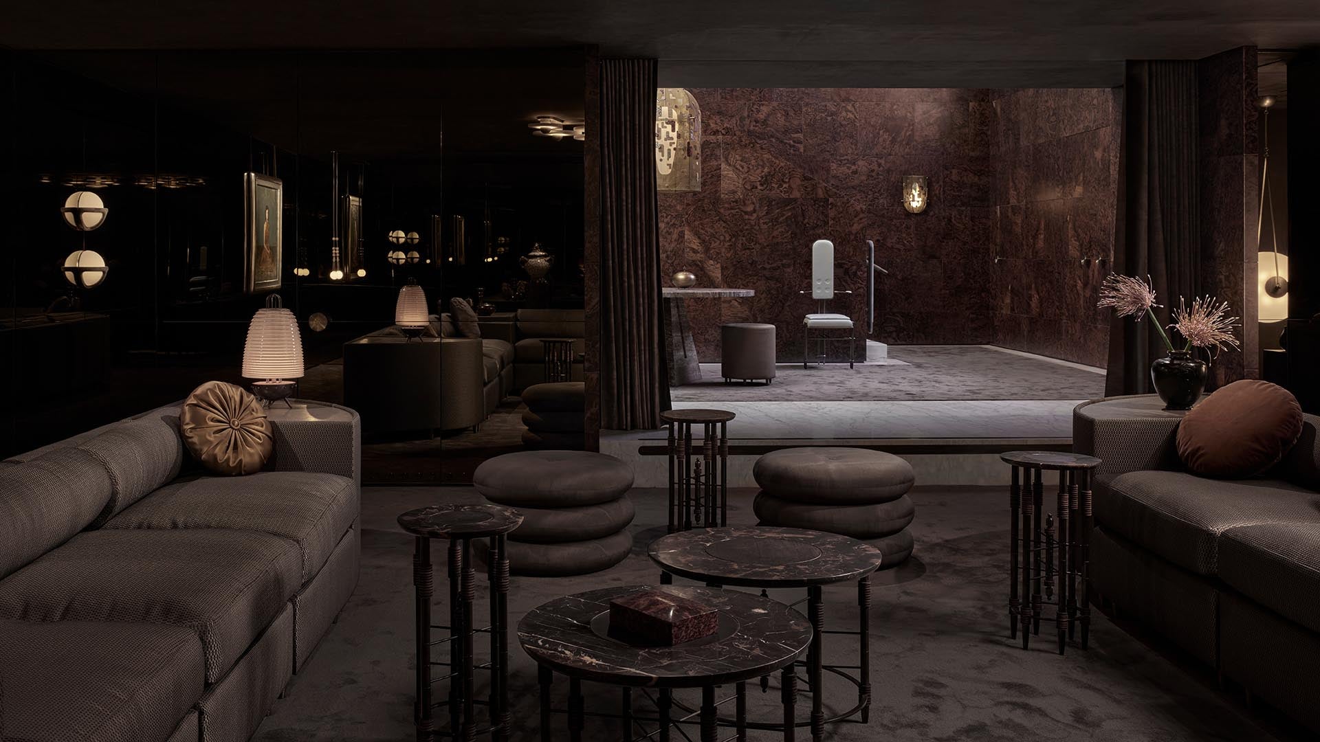 Dimly lit modern lounge area with plush seating, round marble tables, and a luxurious open bathroom in the background