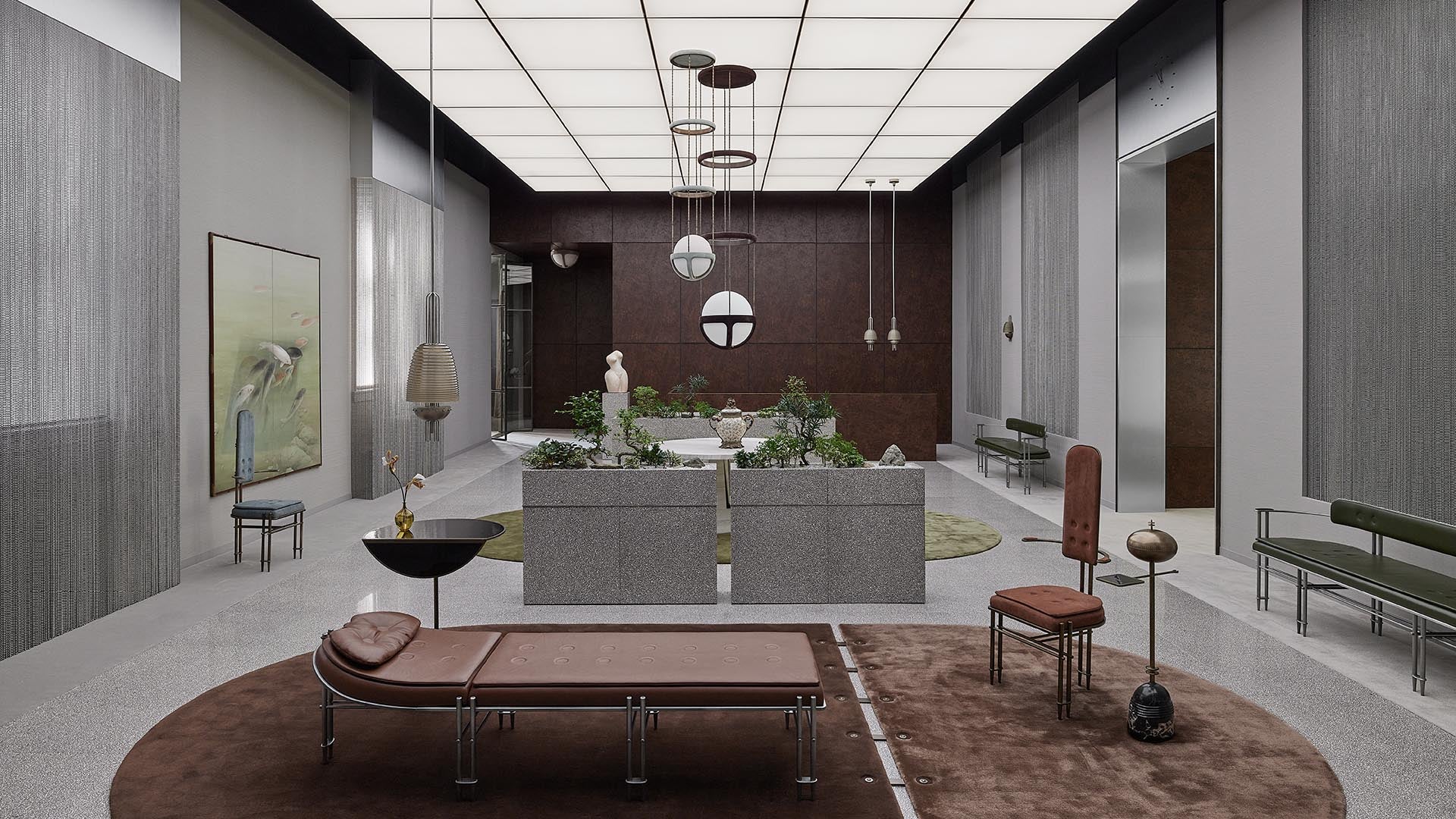 Spacious modern interior with gray stone seating, brown leather chaise lounge, tall windows, and hanging pendant lights over plants