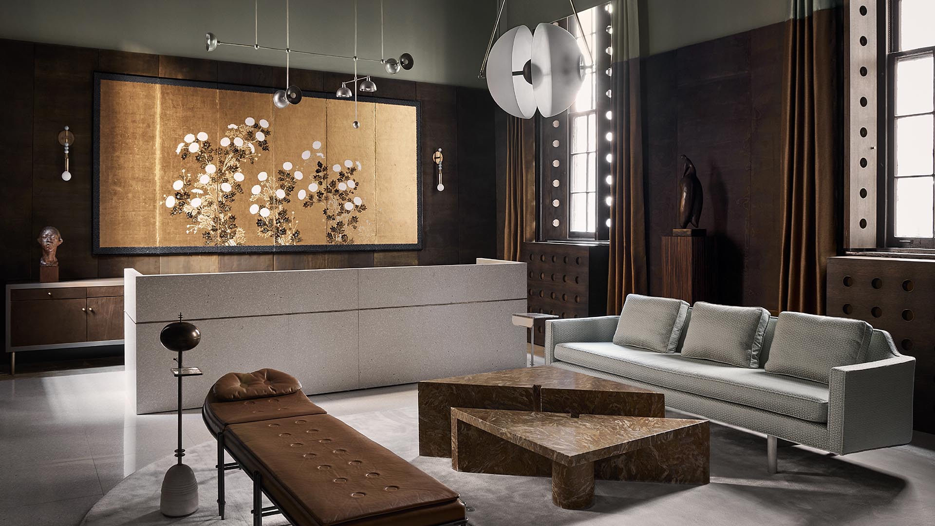 Modern living room with gray sofa, brown chaise lounge, geometric marble coffee table, and large decorative wall art panel