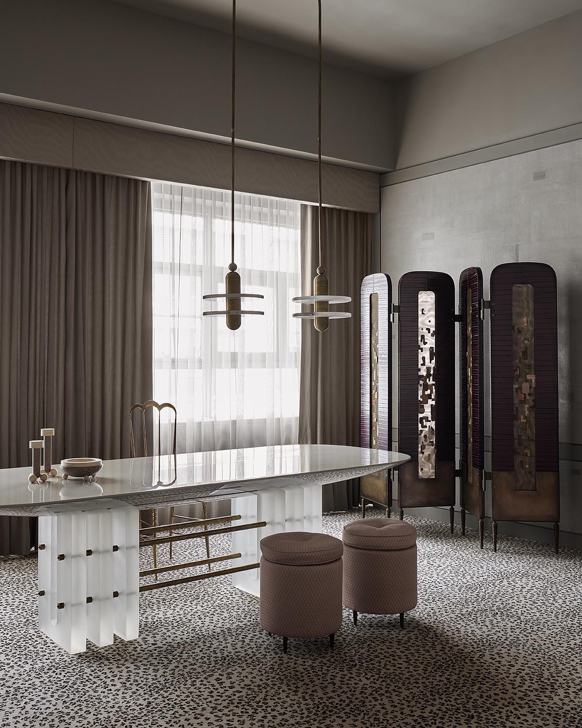 Modern dining room with a white marble table, two fabric stools, pendant lights, and a dark folding screen divider