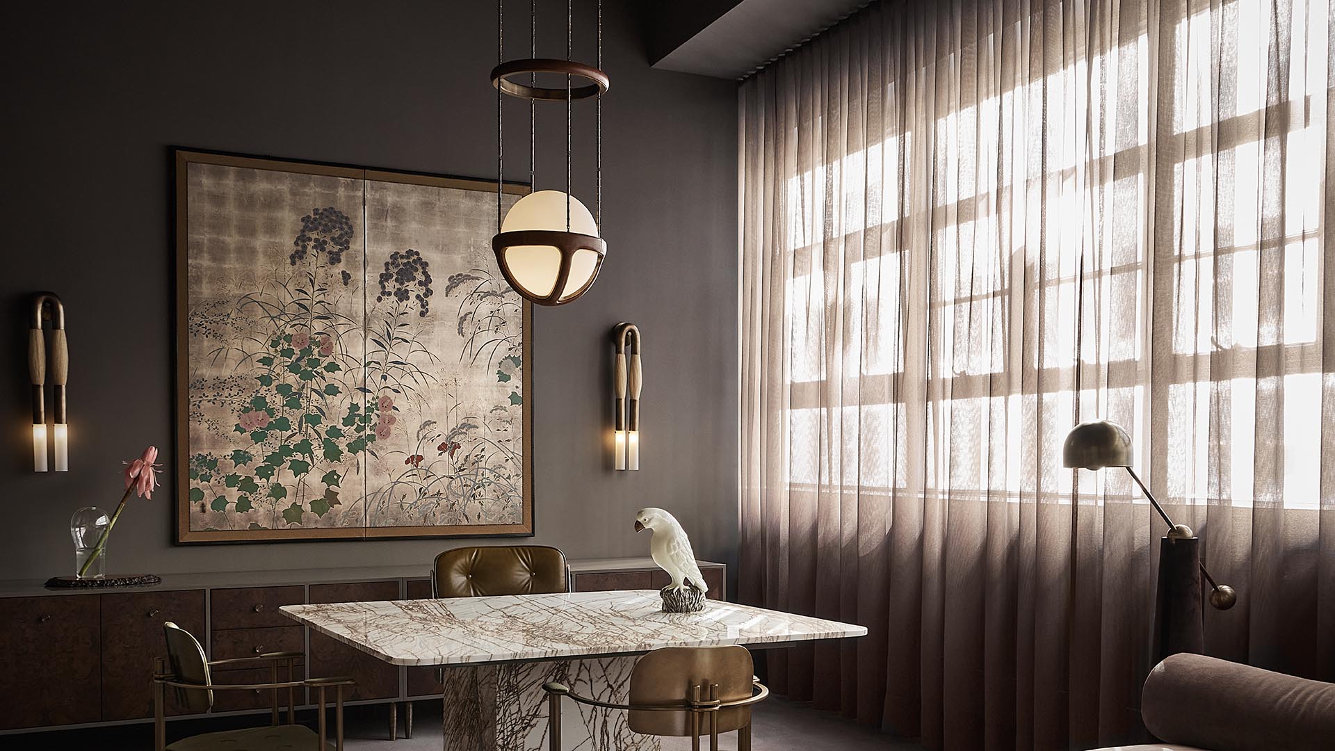 Modern dining area with marble table, leather chairs, large floral artwork, pendant light, and sheer curtains in soft lighting
