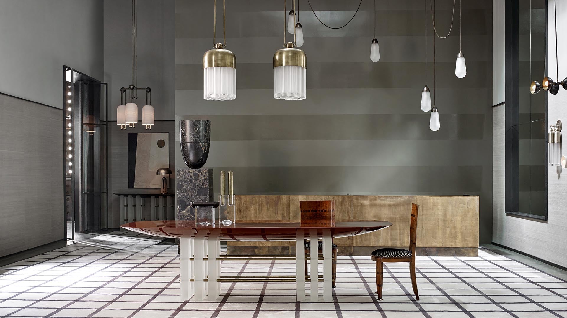 Spacious modern room with a glossy oval wooden table, single chair, pendant lights, and abstract wall art on tiled floor