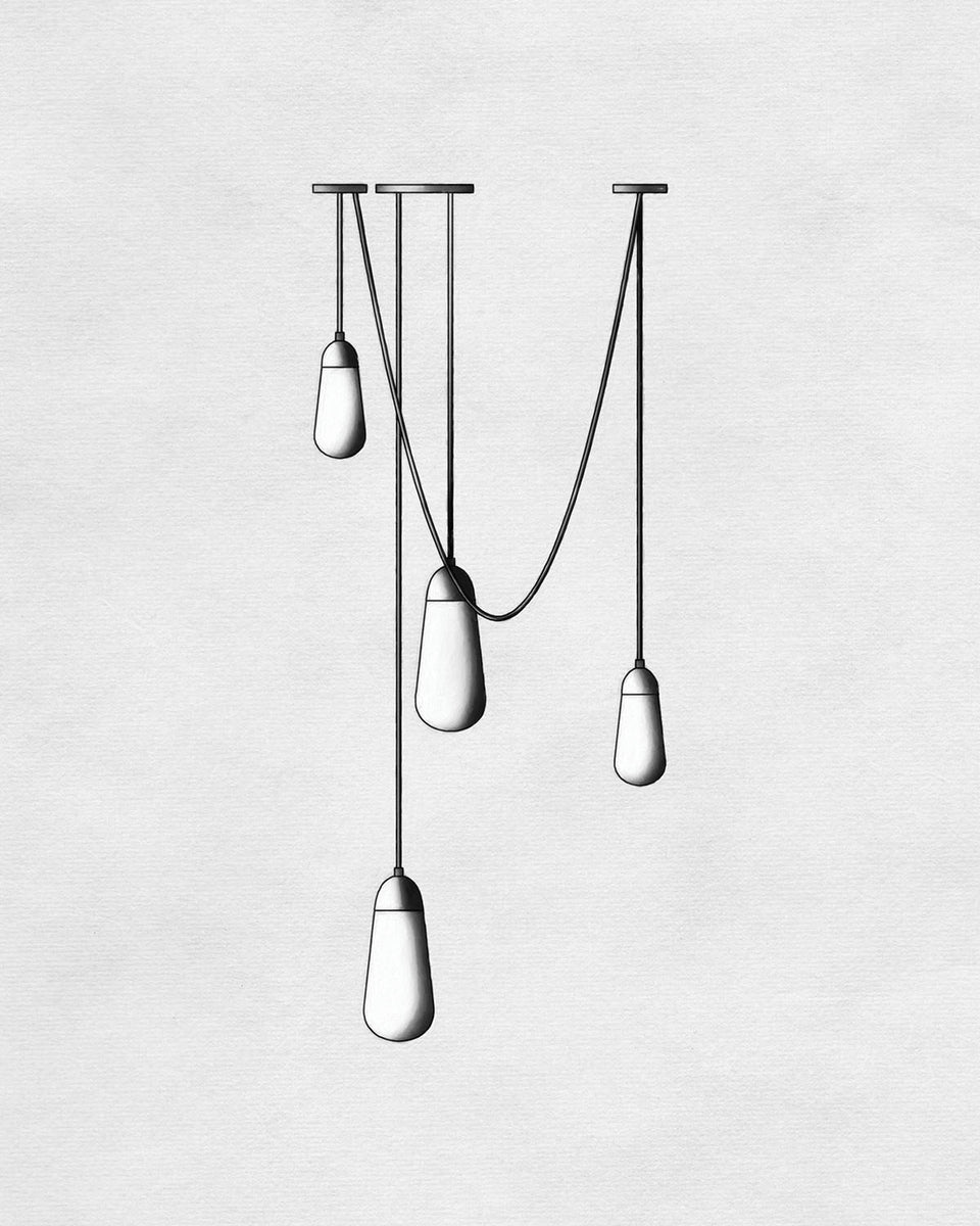 Minimalist ceiling light fixture with four elongated bulbs suspended at varying heights on thin black cords against a light background