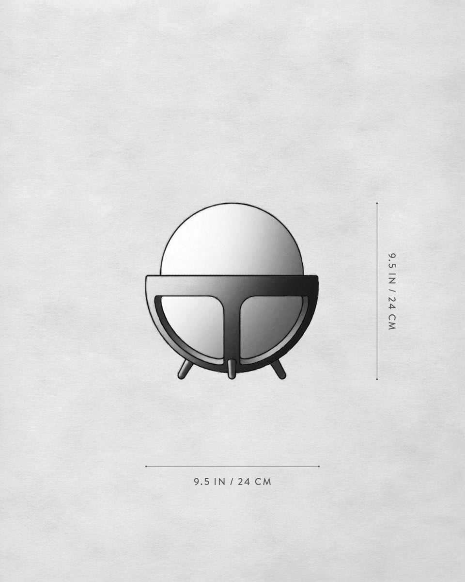 Top-down view of a round mirror with a thick frame and three short legs on a light textured surface with measurements.