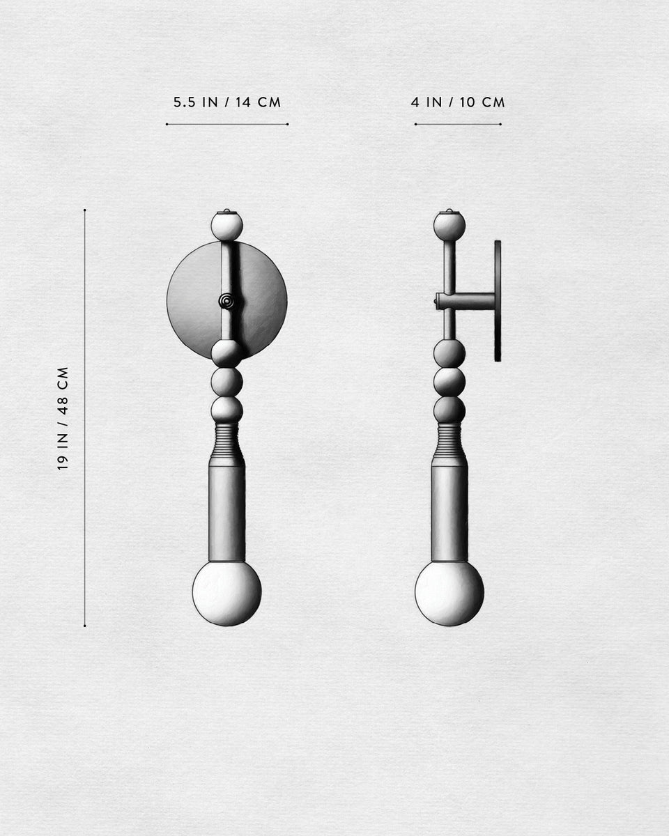 Technical drawing of a decorative wall hook showing front and side views with dimensions in inches and centimeters.