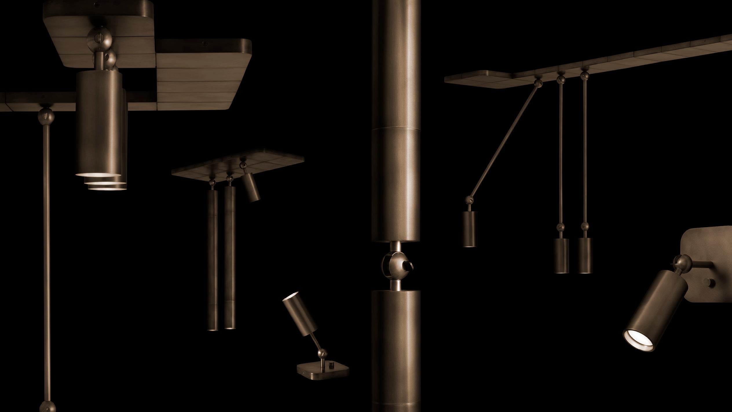 Close-up of various modern metallic pendant and spotlight fixtures with dark bronze finish against a black background