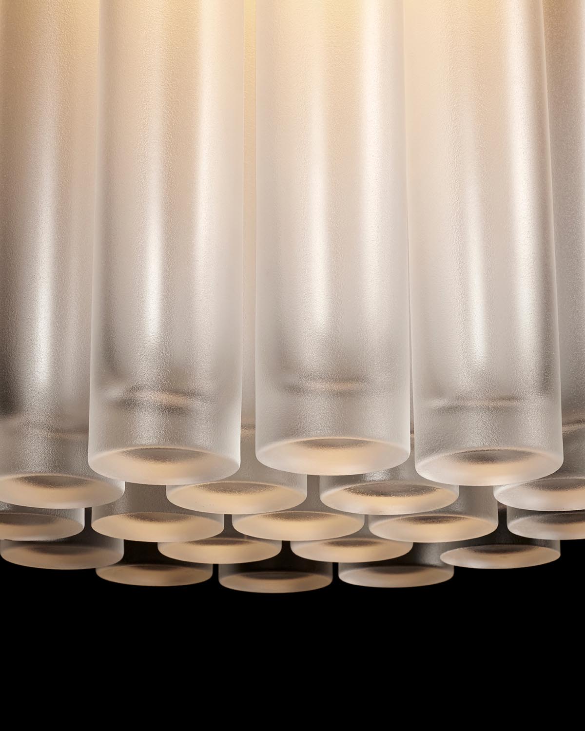 Close-up view of frosted glass cylindrical tubes arranged in a honeycomb pattern against a dark background