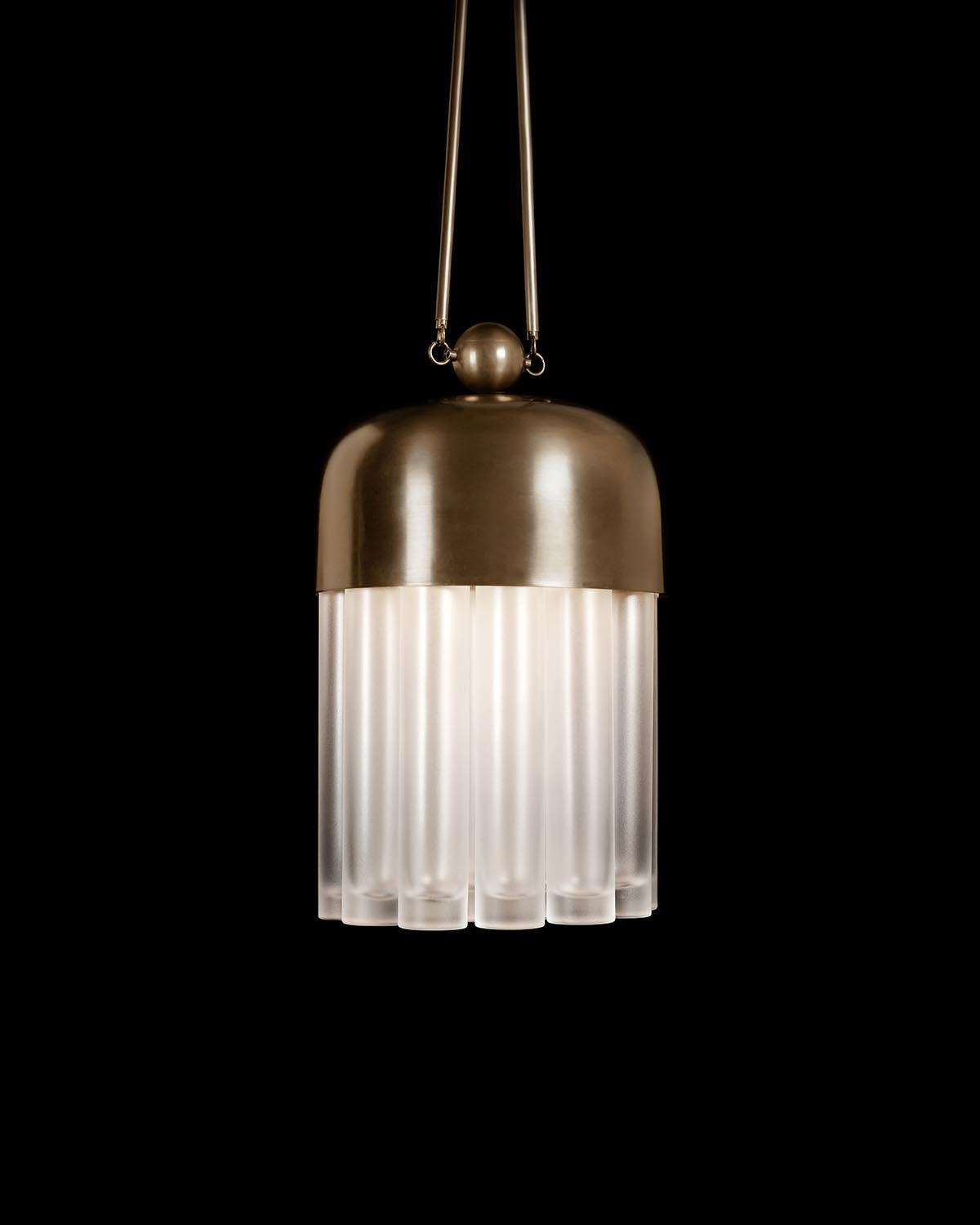 Pendant light with matte brass dome top and a cluster of frosted vertical glass tubes hanging against black background