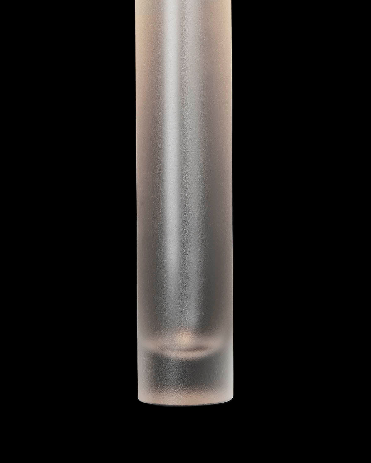 Close-up of a frosted cylindrical glass pendant light with smooth texture against a black background