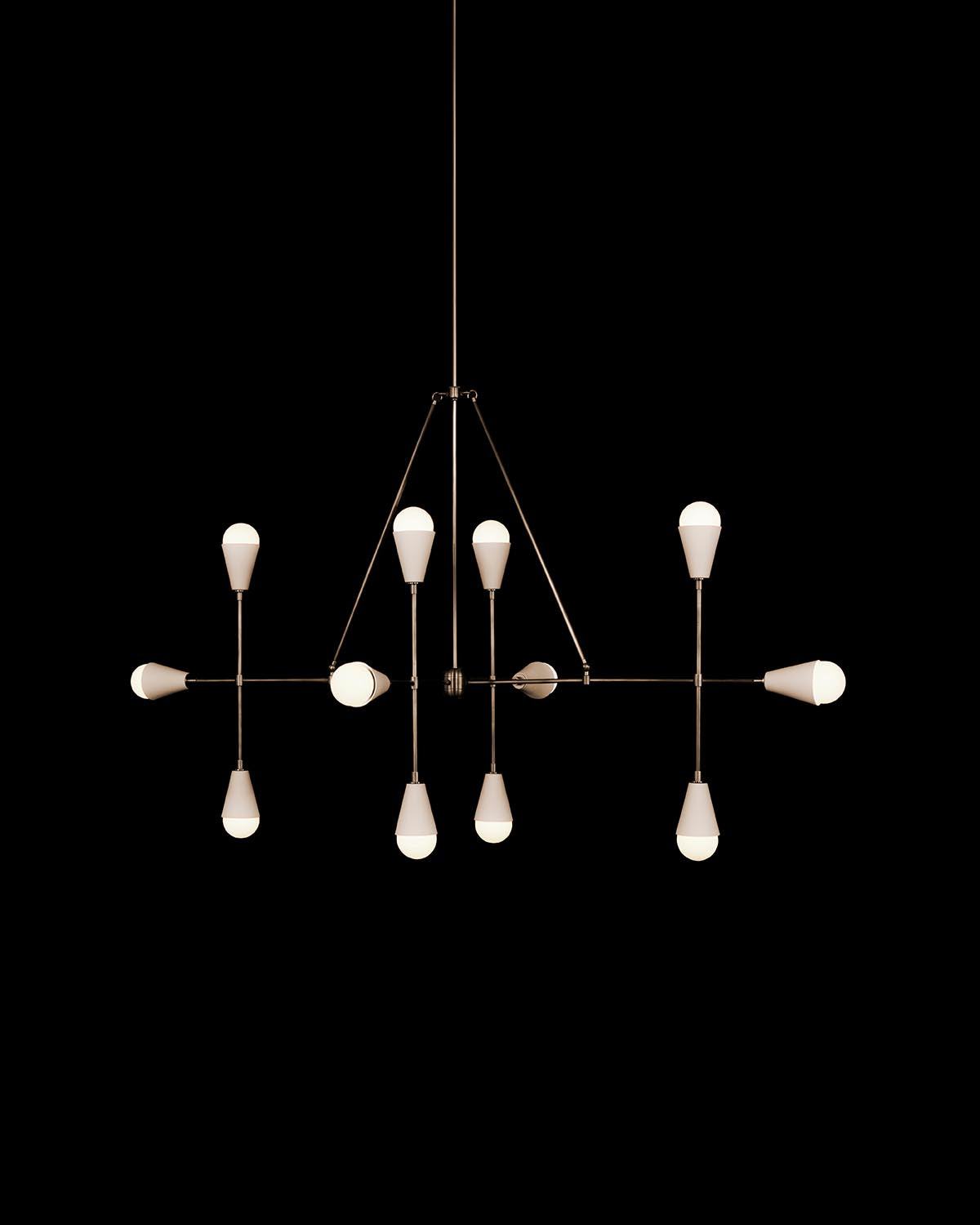 Modern linear pendant light with twelve cone-shaped bulbs arranged on thin dark metal rods against black background