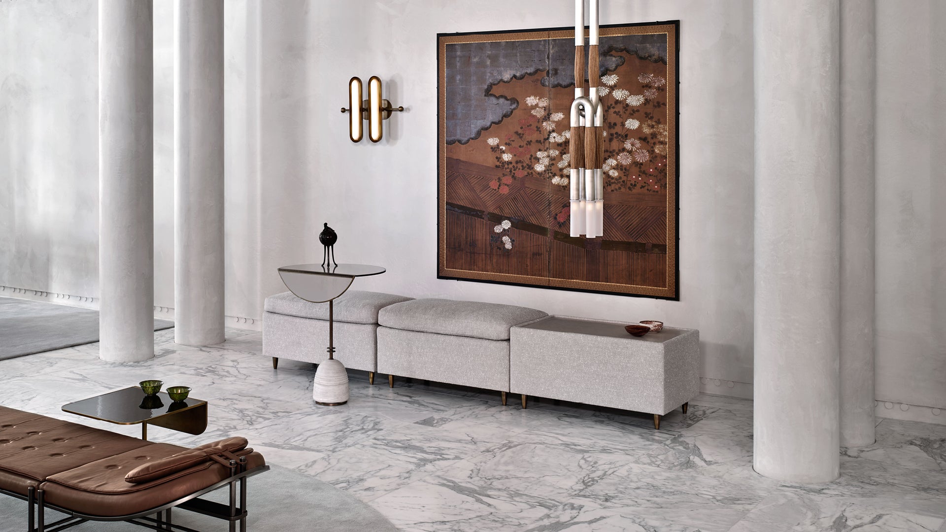 Modern minimalist interior with beige sofa, large abstract wall art, marble floor, white columns, and sculptural side table